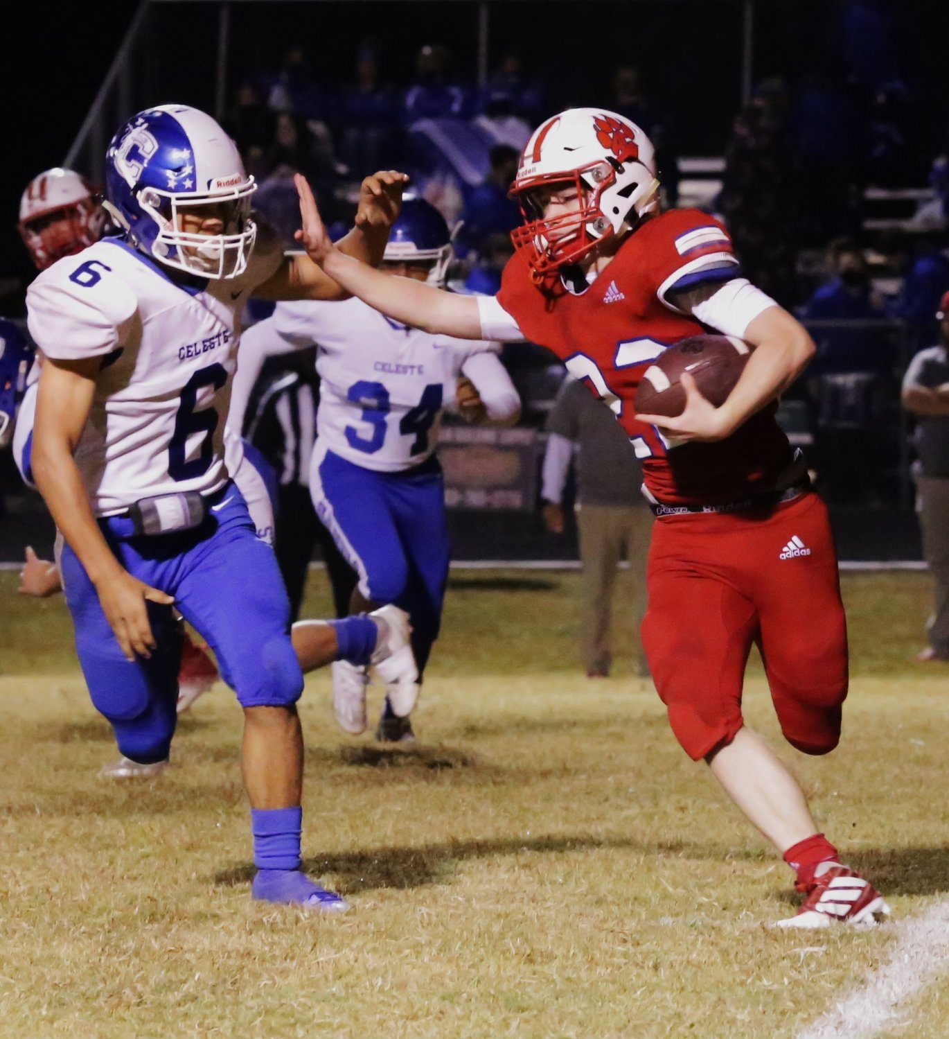Panther Glen Hartley uses a stiff-arm to gain the edge in action against Celeste. (Monitor photo by John Arbter)